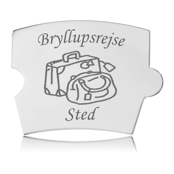 Memozz Spin brik i håndpoleret rustfrit stål med gravering af en kuffert og en taske, samt teksten "Bryllupsrejse" og "Sted".
