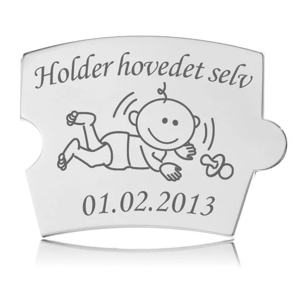 Memozz Spin brik i poleret rustfrit stål med gravering af glad baby og teksten "Holder hovedet selv"
