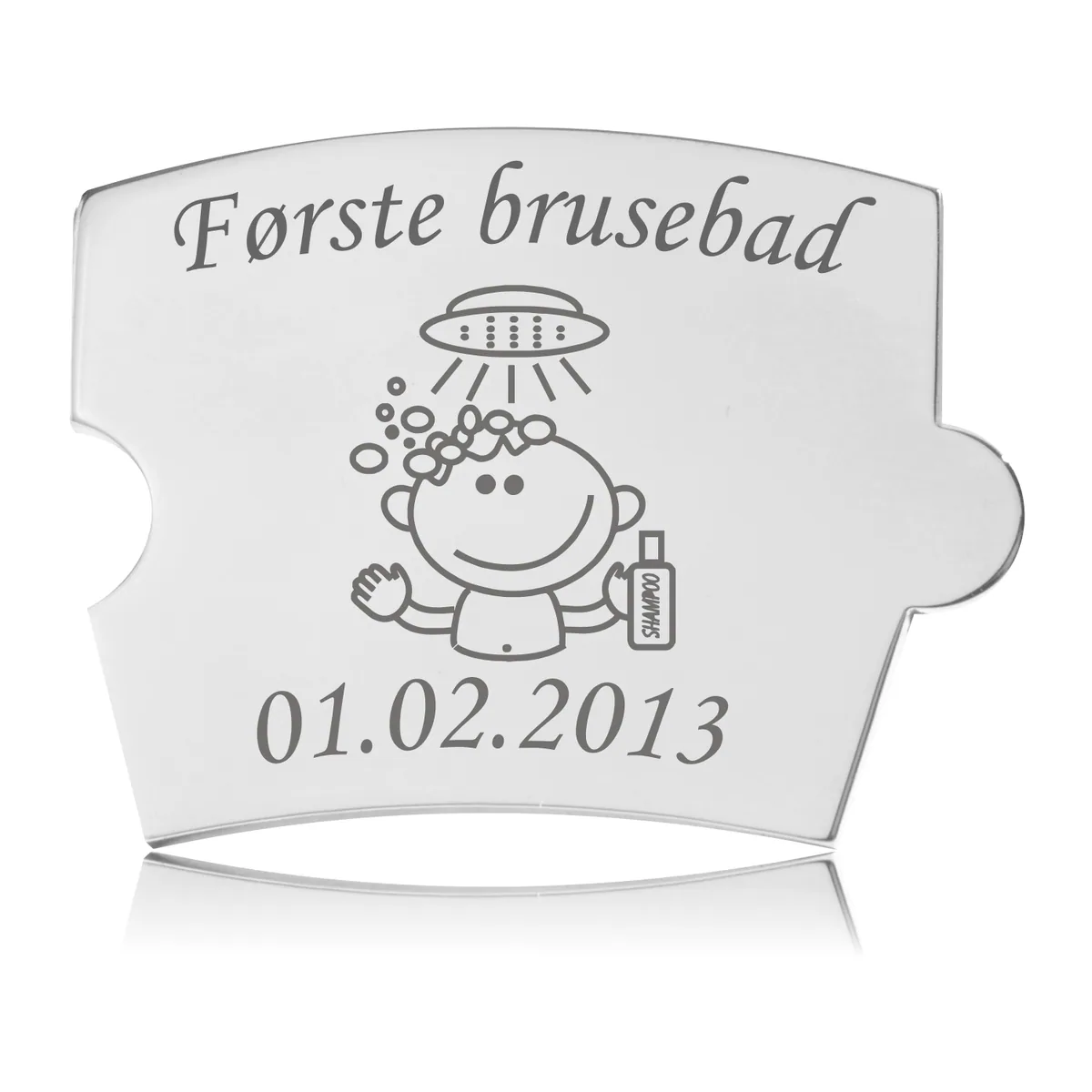 Memozz Spin brik i rustfrit stål med gravering af en glad baby i badekar og teksten "Første brusebad"